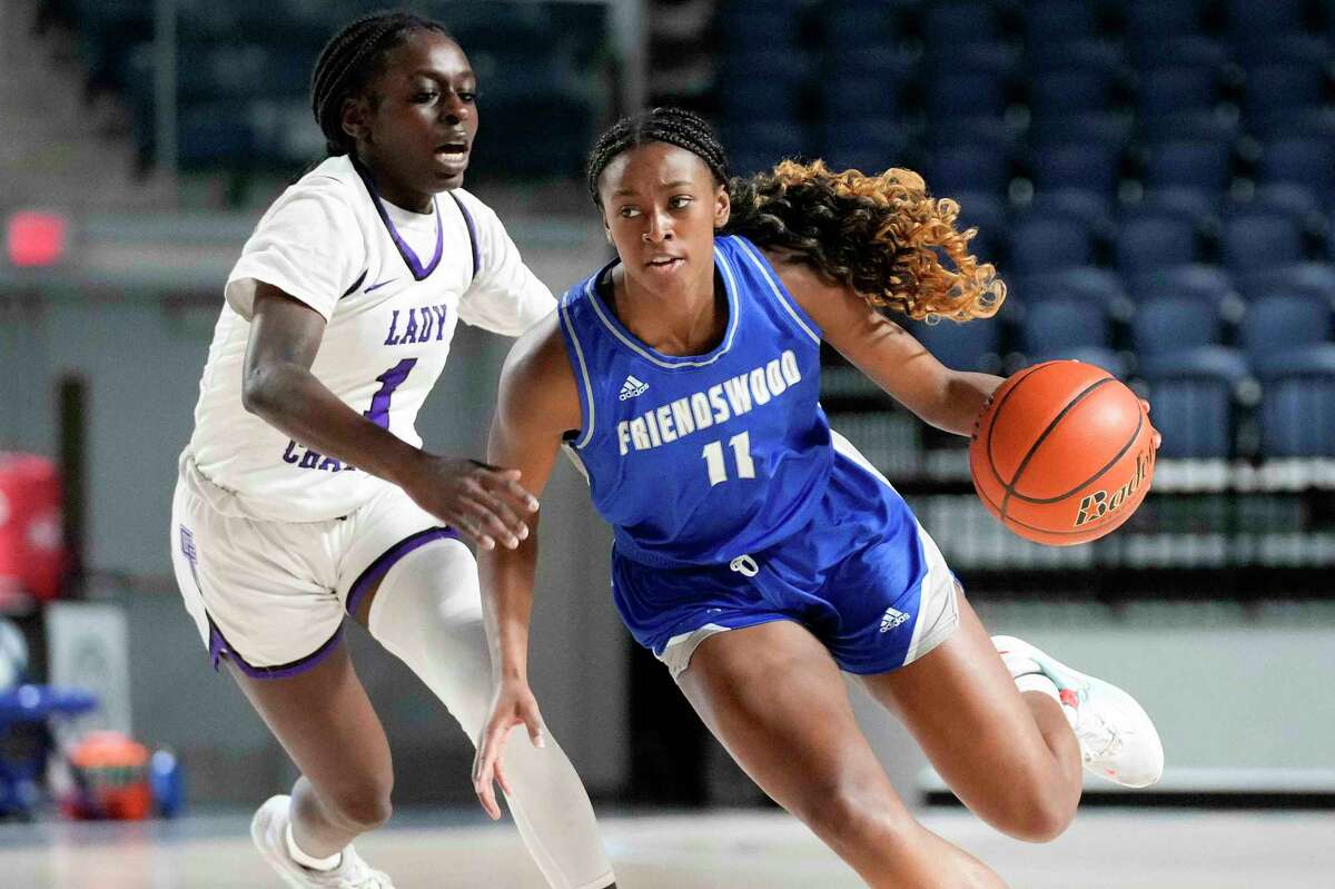 Friendswood guard Nadi’ya Shelby (11) dribbles as Fulshear forward Ese Ogbevire defends during the first half of a Region III-5A area high school basketball playoff game, Thursday, Feb. 16, 2023, in Houston.