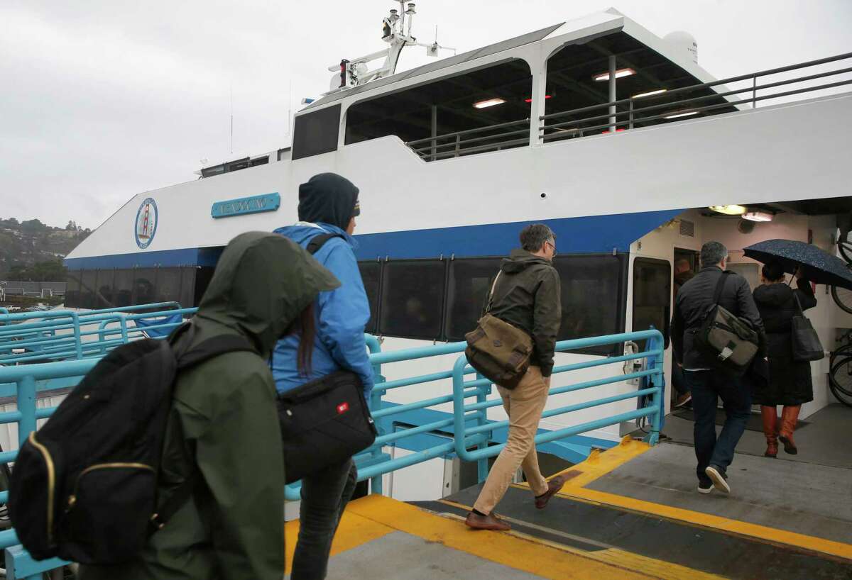 Passengers board a Golden Gate Ferry boat headed for San Francisco at the Larkspur Ferry Terminal in Larkspur, Calif., in 2018. The transit agency is consider fare increases.