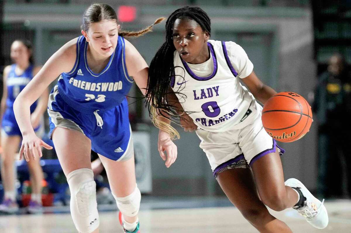 Fulshear guard Ruke Ogbevire (0), who scored a game-high 22 points, dribbles past Friendswood guard Helen Byrd during the second half of their Region III-5A playoff game Tuesday night at Delmar Fieldhouse.