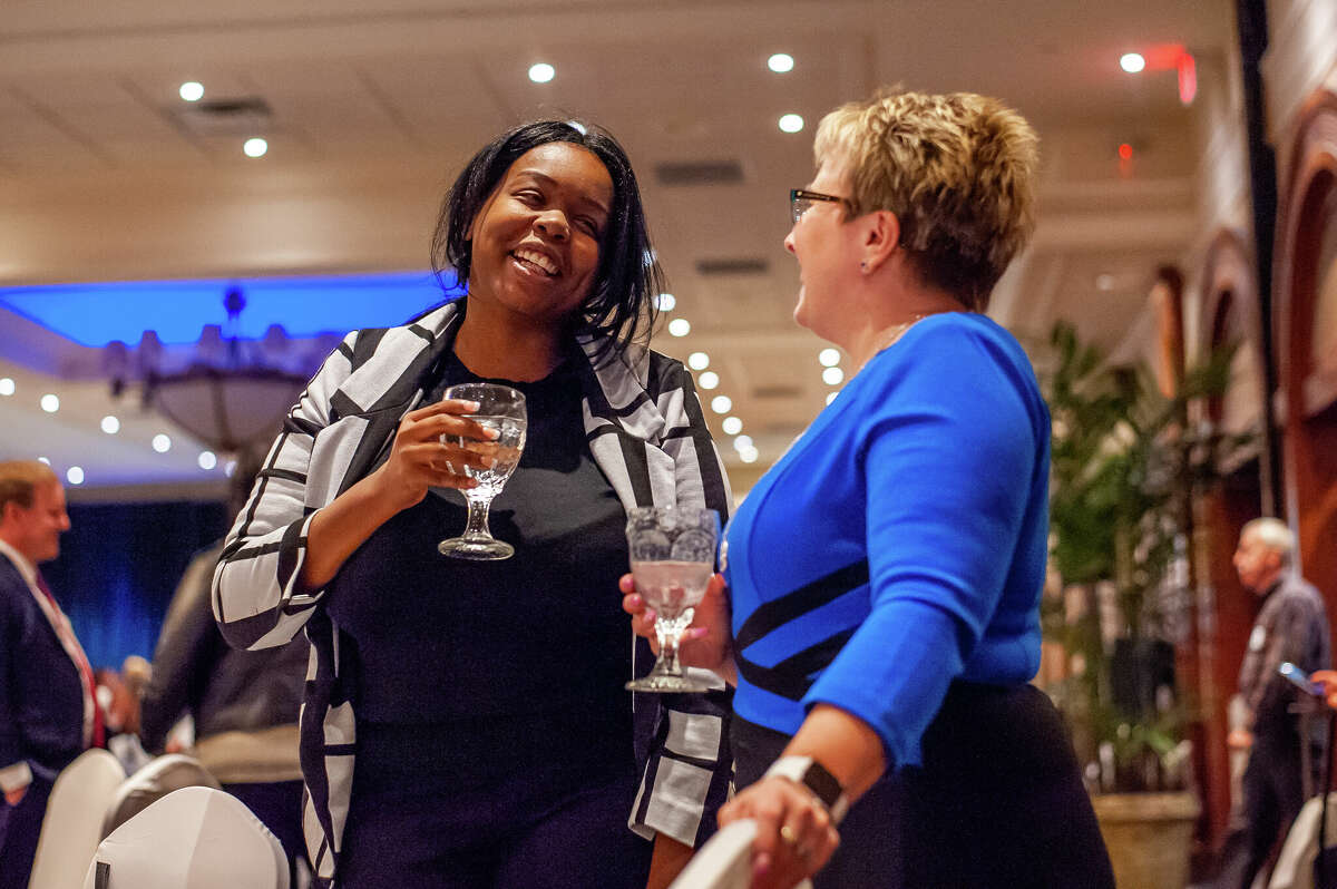 Midland residents LaShanta Green (left) and Sheila Wright chat at the Midland Business Alliance's annual meeting on Feb. 16, 2023 at the Great Hall in Midland.
