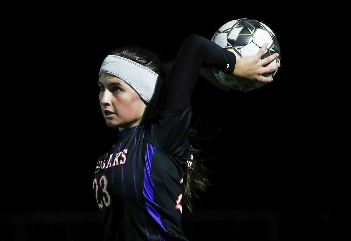 Grand Oaks' Ella Jo Weninger (23) throws the ball in bounds in the first half of a District 13-6A high school soccer match at Grand Oak High School, Thursday, Feb. 16, 2023, in Spring.