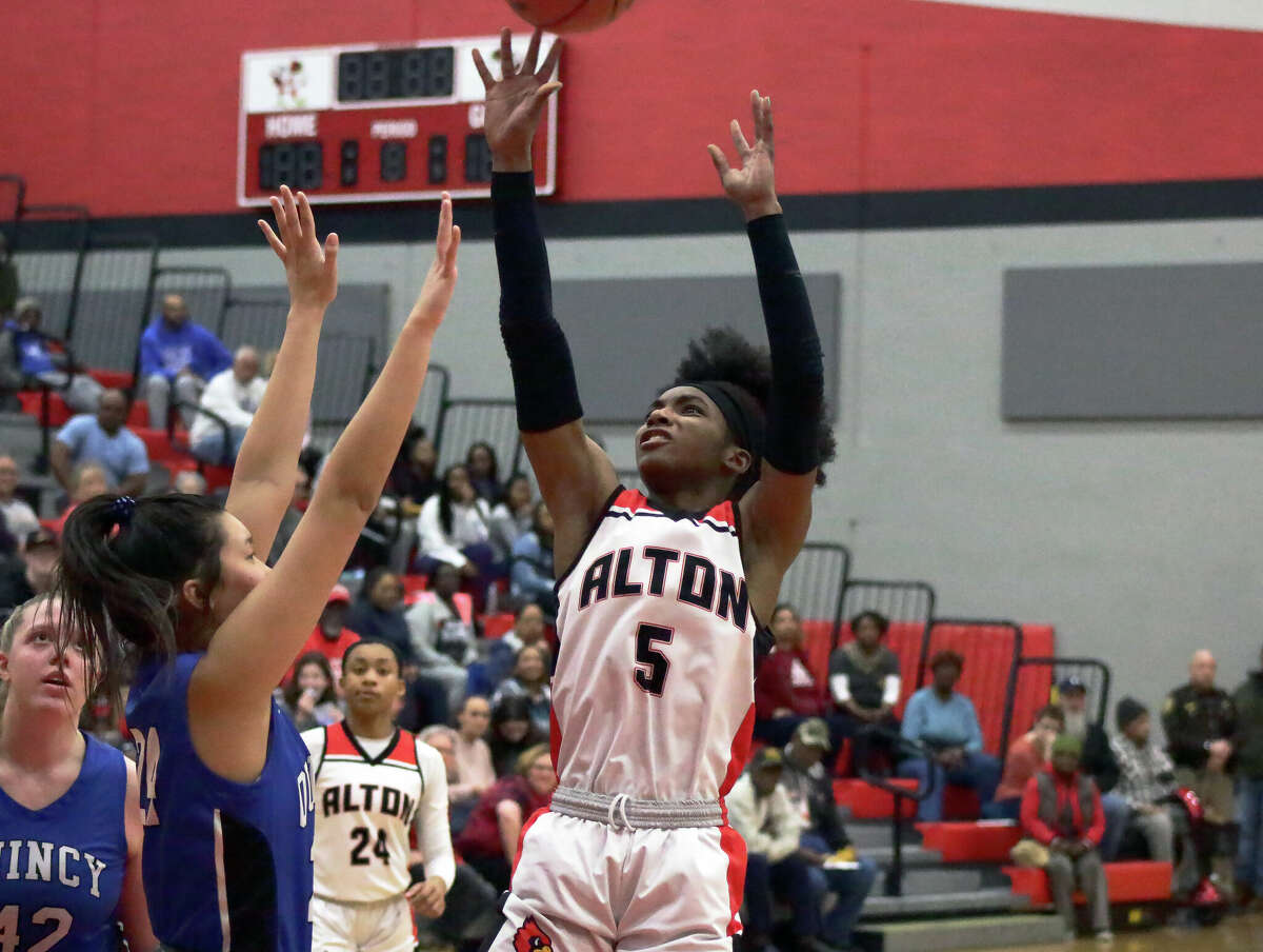Alton's Kaylea Lacey puts up a shot during the Redbirds' 58-31 win against Quincy in the Class 4A Alton Regional championship game Thursday night at Alton High School.