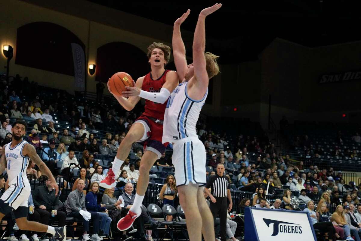 Saint Mary's guard Aidan Mahaney, left, shoots as San Diego center Nic Lynch defends during the second half of an NCAA college basketball game Thursday, Feb. 16, 2023, in San Diego. (AP Photo/Gregory Bull)