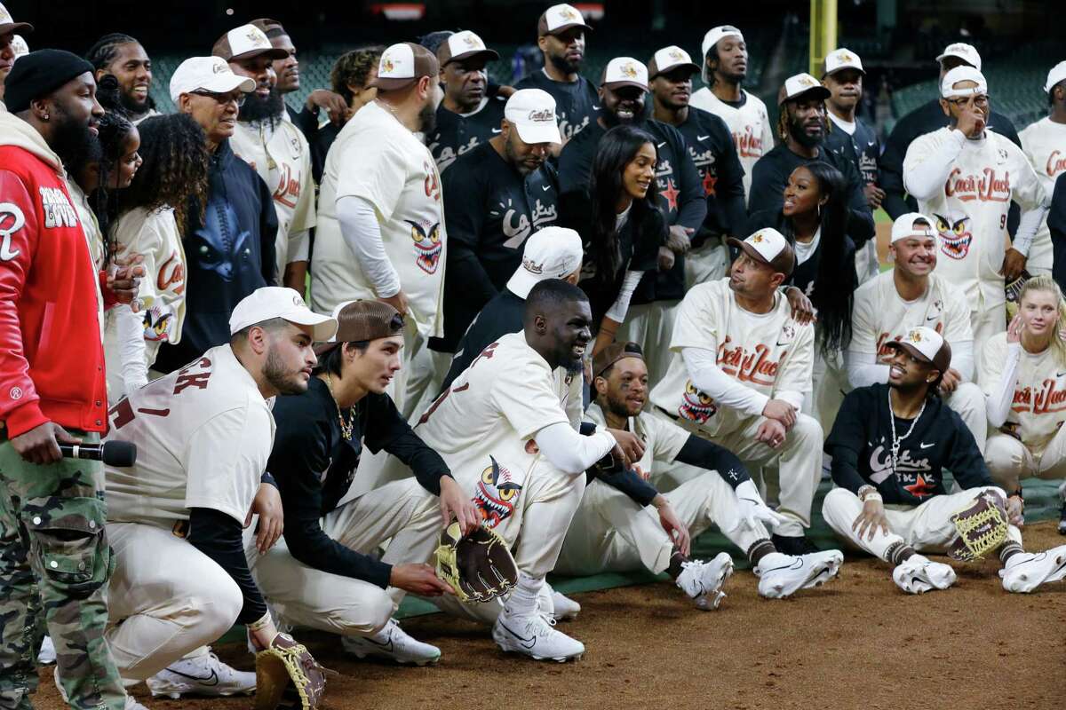 Players from both the Cream Team and Black team gather for a group photo after the Travis Scott Celebrity Softball game held at Minute Maid Park Thursday, Feb. 16, 2023 in Houston.
