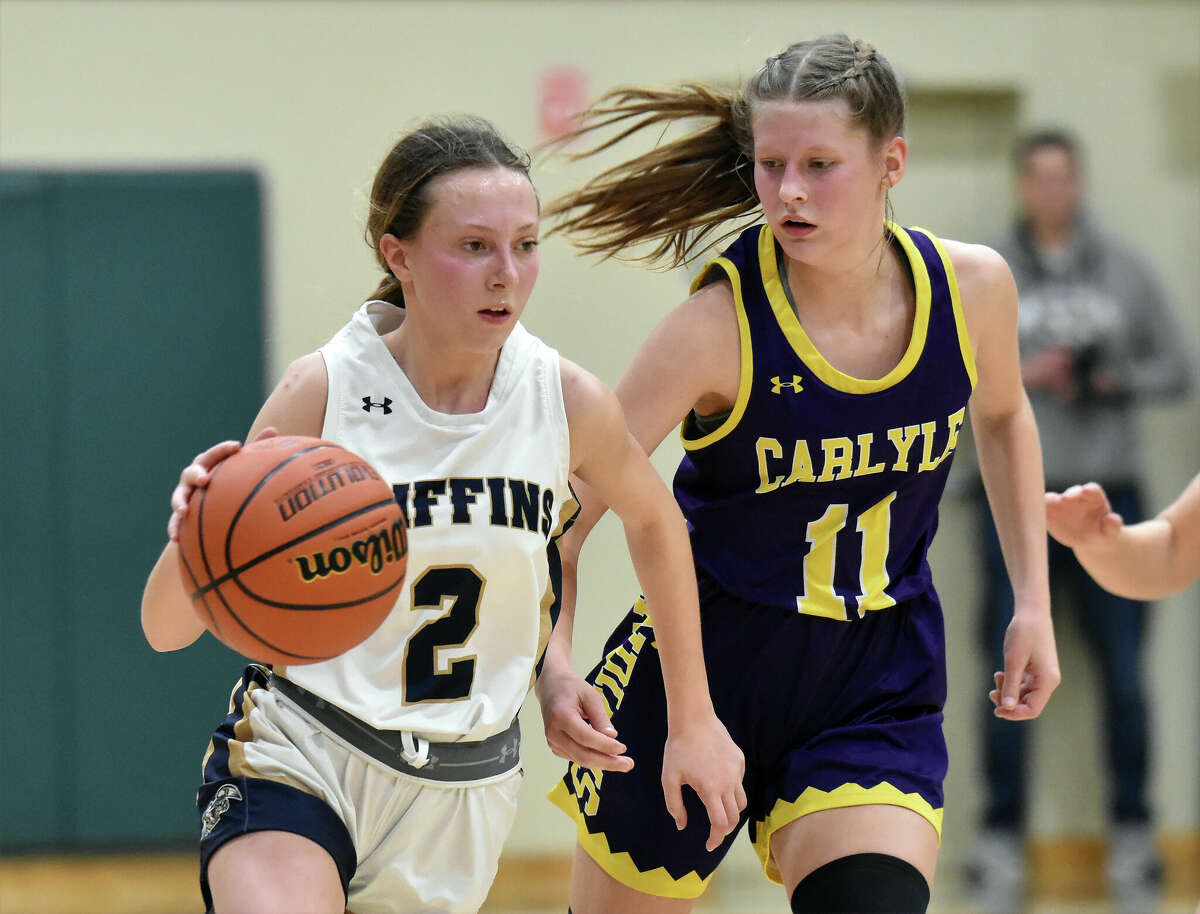 Father McGivney's Claire Stanhaus races up the court against Carlyle in the Class 1A Metro-East Lutheran Regional championship game in Edwardsville.