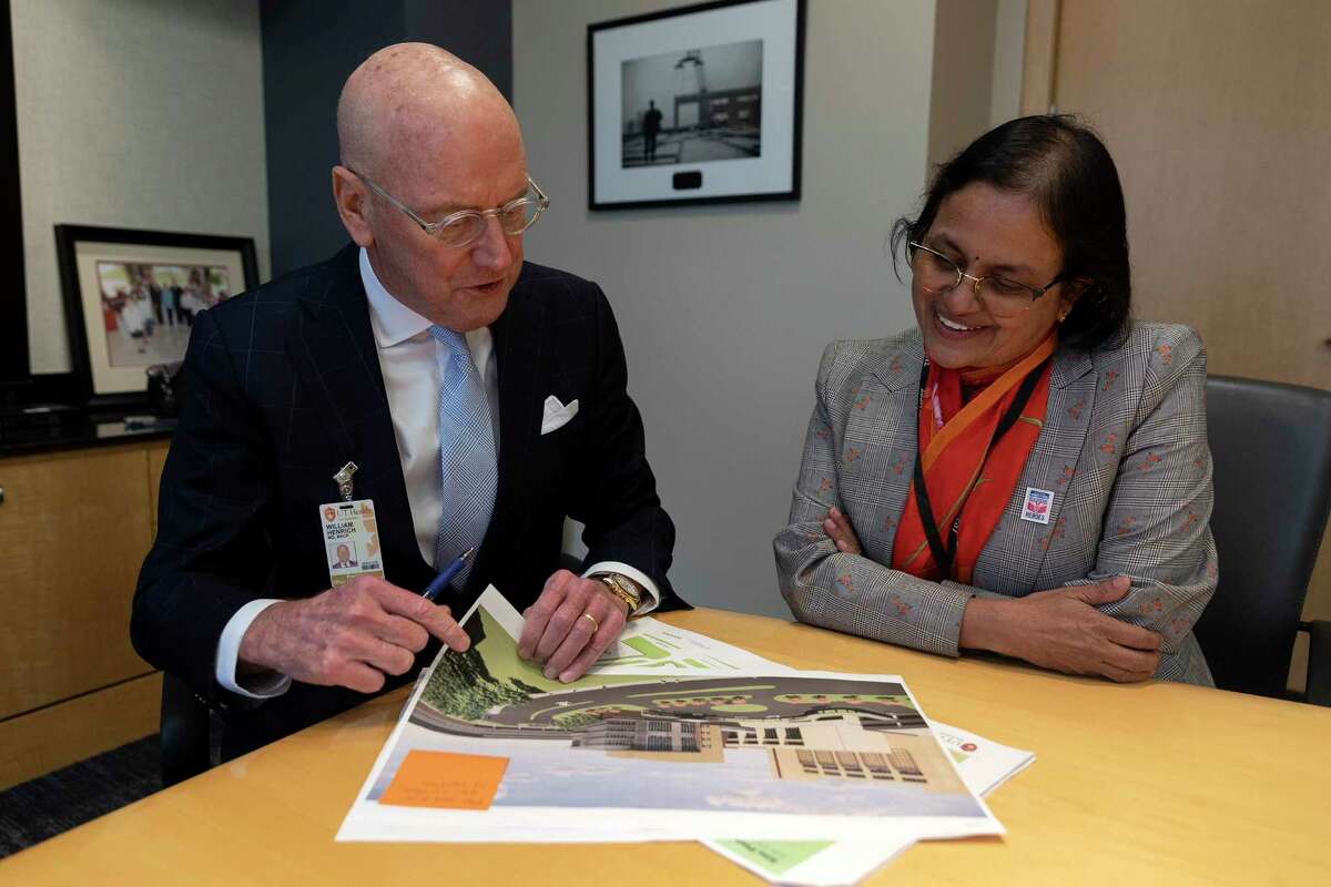 UT Health president Dr. William Henrich and Biggs Institute director Dr. Sudha Seshadri review plans for a planned $100 million facility to study and treat Alzheimer’s, Parkinson’s and other diseases and related dementia.