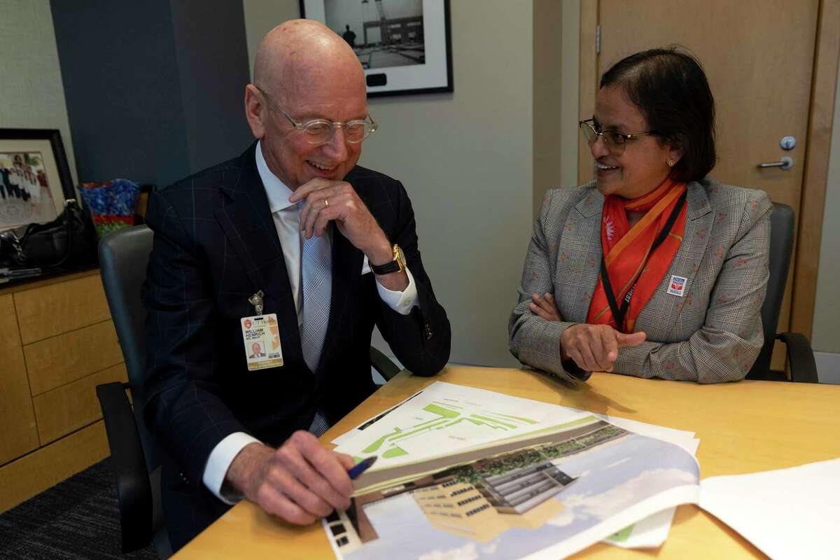 UT Health president Dr. William Henrich and Biggs Institute director Dr. Sudha Seshadri review plans for a planned $100 million facility to study and treat Alzheimer’s, Parkinson’s and other diseases and related dementia.
