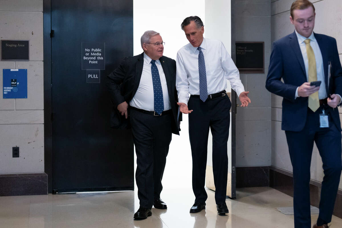 Senate Foreign Relations Chairman Robert Menendez, D-N.J., left, and Sen. Mitt Romney, R-Utah, depart after a closed briefing on the unknown aerial objects the U.S. military shot down this weekend at the Capitol in Washington, Tuesday, Feb. 14, 2023. 