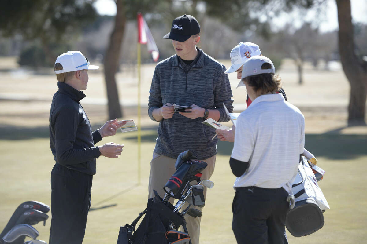 Andrews' Jack Burgen, center, Midland High's Carter Tipton, left, and Legacy's Drew Ironside, front right, look over their scorecards at the 18th green during the Tall City Invitational golf tournament, Feb. 17 at Ranchland Hills Golf Club. 