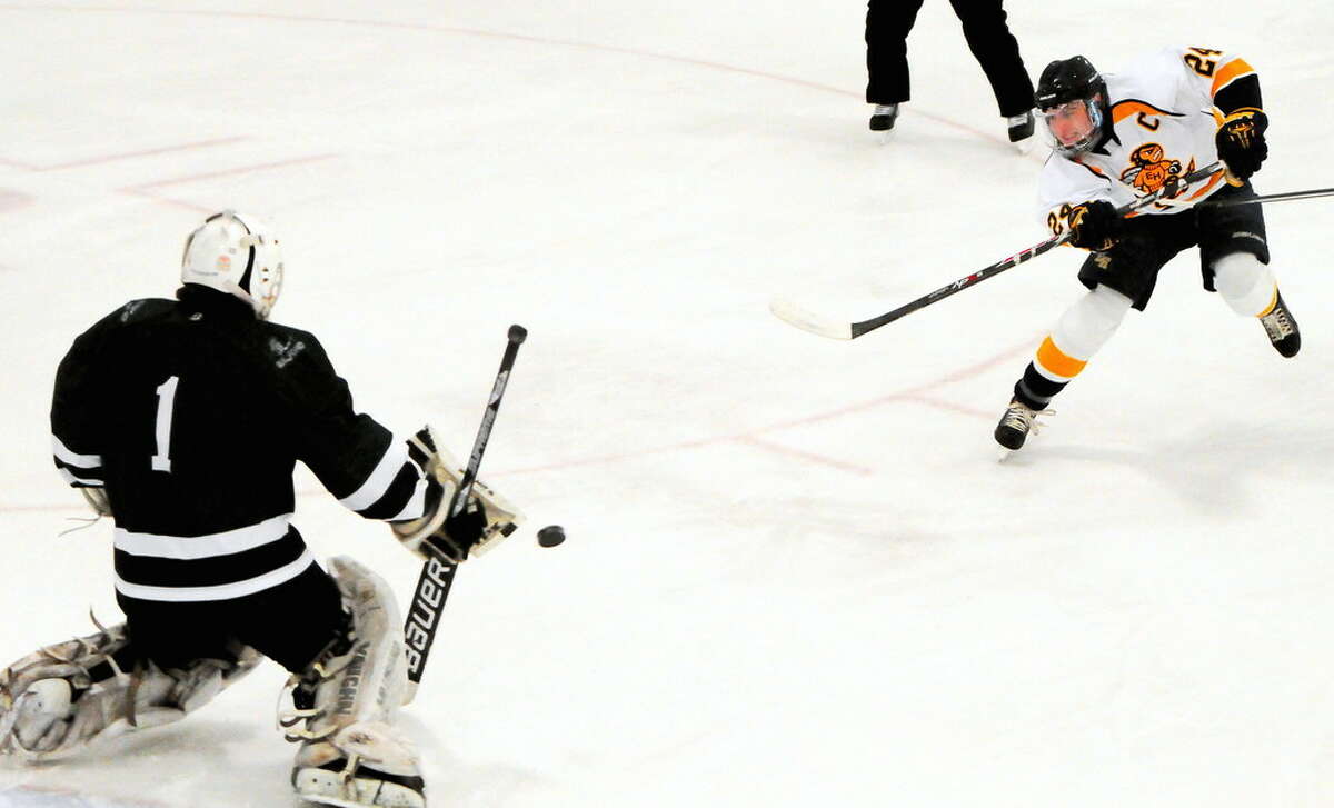 An East Haven High School hockey player scores a goal against Guilford H.S. during a 2014 game. The East Haven Board of Education is considering tightening academic eligibility requirements for student athletics, a move that could possibly prevent dozens from competing.