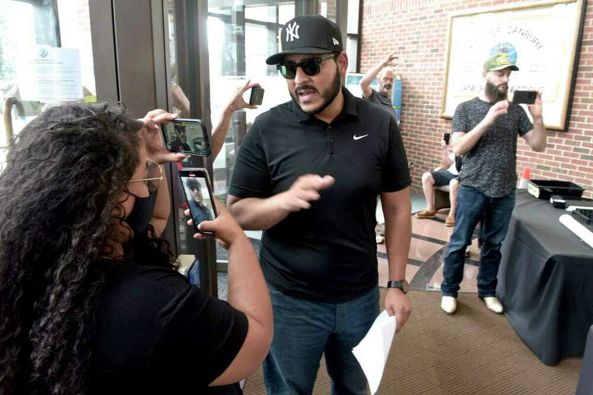 SeanPaul Reyes led a protest in front of and in the main lobby of Danbury City Hall, where he and his supporters streamed live video from their phones on July 19, 2021.