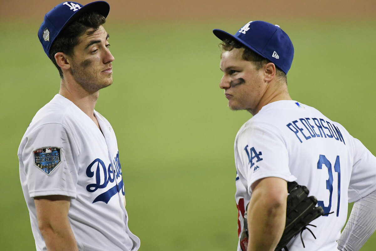 Cody Bellinger #35 and Joc Pederson #31 of the Los Angeles Dodgers react after their team allowed a thirteenth inning run to the Boston Red Sox in Game Three of the 2018 World Series at Dodger Stadium on October 26, 2018 in Los Angeles, California.