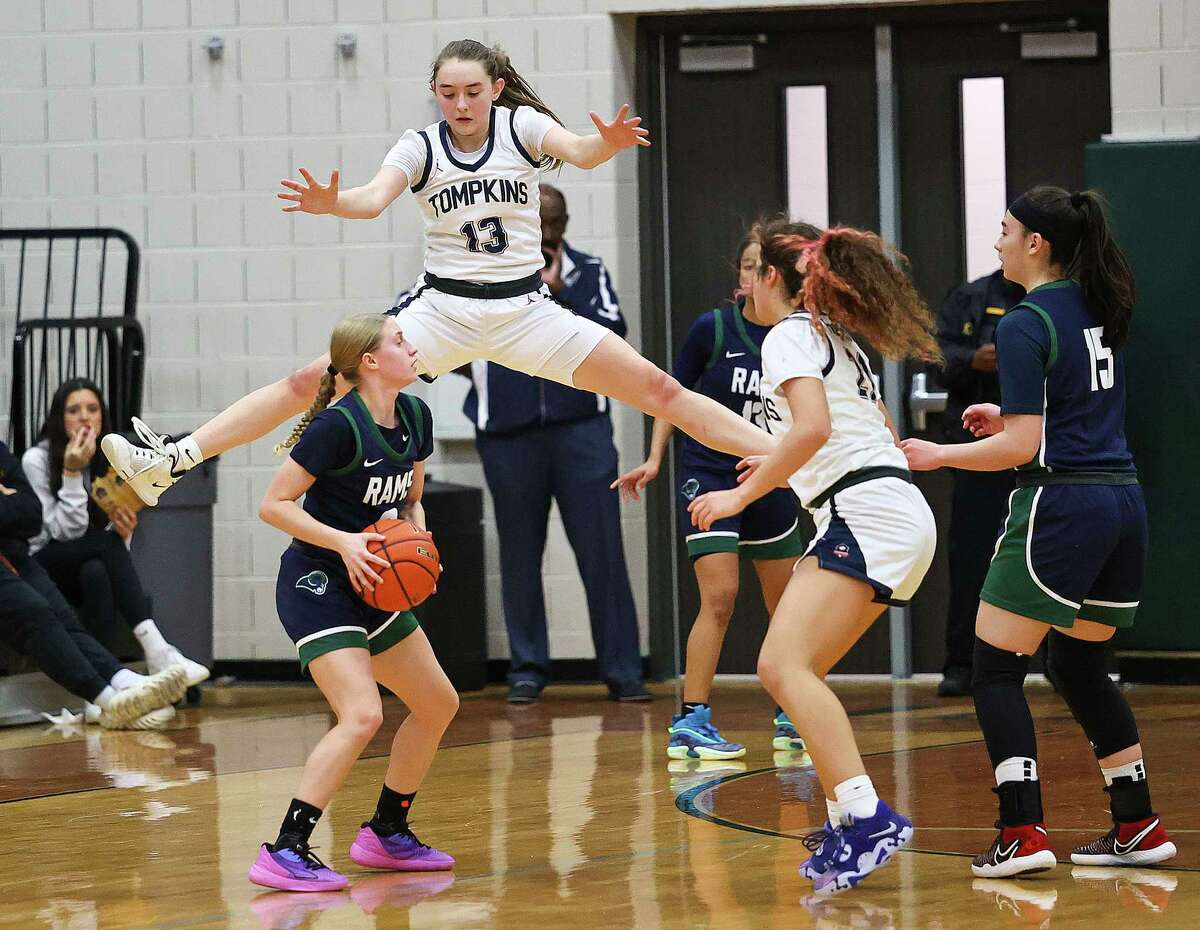 HOUSTON, TX -FEBRUARY 17: Cypress Ridge Rams Olivia Shook (0) looks for a teammate as Tompkins Falcons Macy Spencer (13) defends during a Region III 6-A girls basketball playoff game at Mayde Creek High School February 17, 2023 in Houston,Texas.
