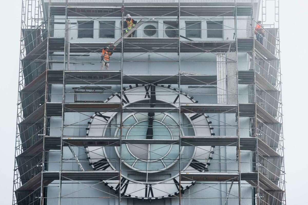 Crews walk across scaffolding erected around the historic tower of the Ferry Building in San Francisco, Calif. Monday, Feb. 13, 2023 during a restoration project