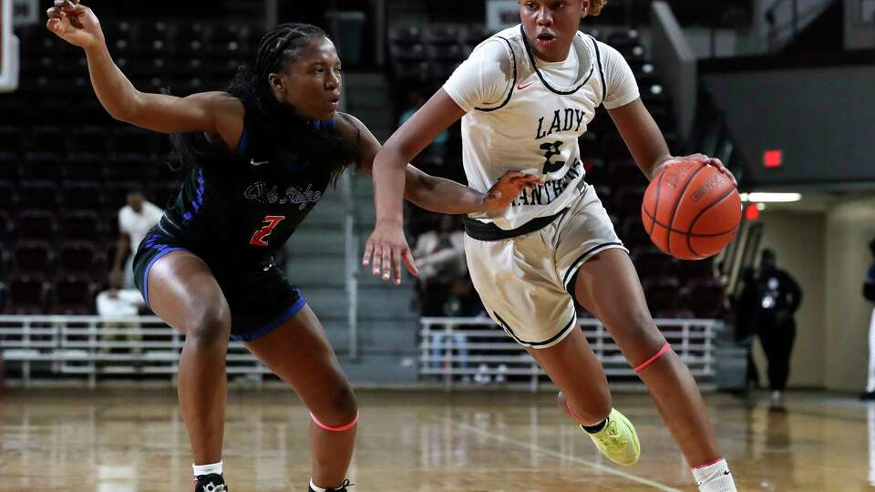 Cypress Springs shooting guard Ayla McDowell (2) drives against Oak Ridge power forward Angel Emeh (2) during the second quarter of a Region II-6A area high school basketball playoff game at the M.O Campbell Center, Friday, Feb. 17, 2023, in Houston.