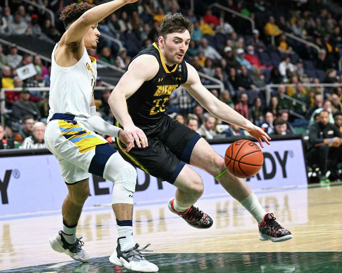 Siena graduate student Andrew Platek drives to the basket in front of Quinnipiac junior Dezi Jones on Friday, Feb. 17, 2023, at MVP Arena in Albany, NY.