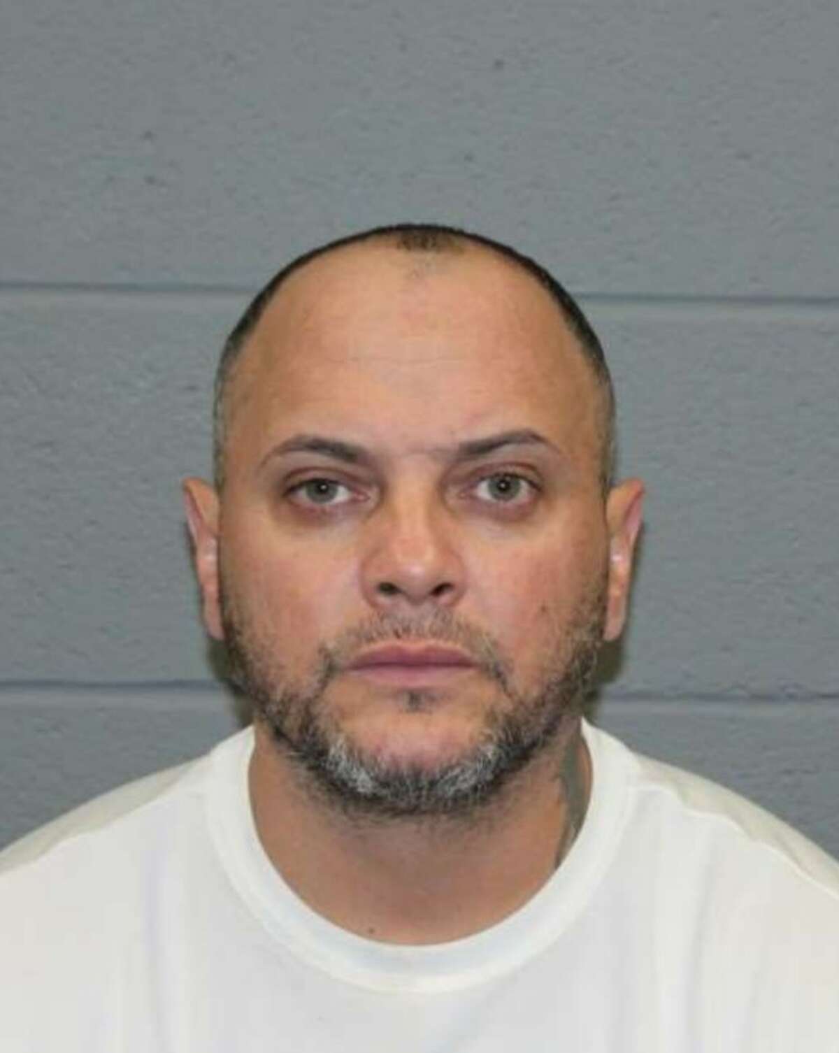 Carlos Baez, 40, was one of eight people arrested on drug charges Monday during a raid on a Baldwin Street business implicated in narcotics trafficking, according to Waterbury police.