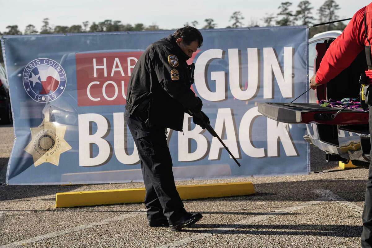 A Harris County Sheriff inspects a rifle which was collected during the Gun Buyback campaign at Alexander Deussen Park on February 18, 2023 in Houston, Texas. Go Nakamura for Houston Chronicle
