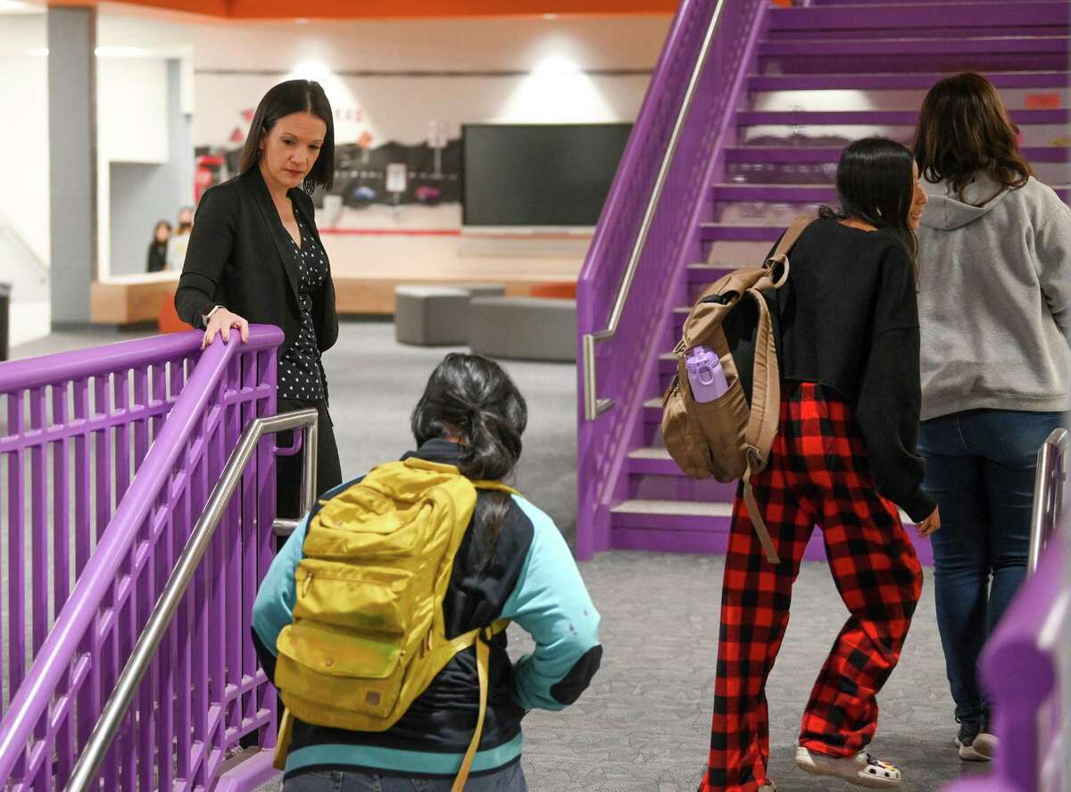 Principal Julie May encourages students to get to class Feb. 7 at Rogers Middle School, which is converting to an all-honors model focused on college readiness. Public school districts have embraced the reality that parents can choose their kids’ schools and are refining and expanding the available options.