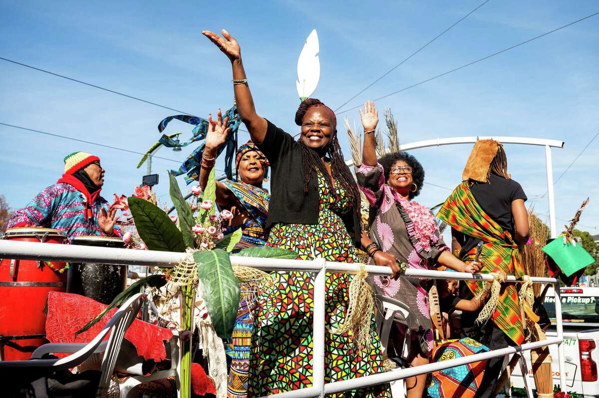 Janice Smith (center) waves from a float during the Black History Month Parade alongside Vivian Ellis (left) and the Rev. Carolyn Scott.
