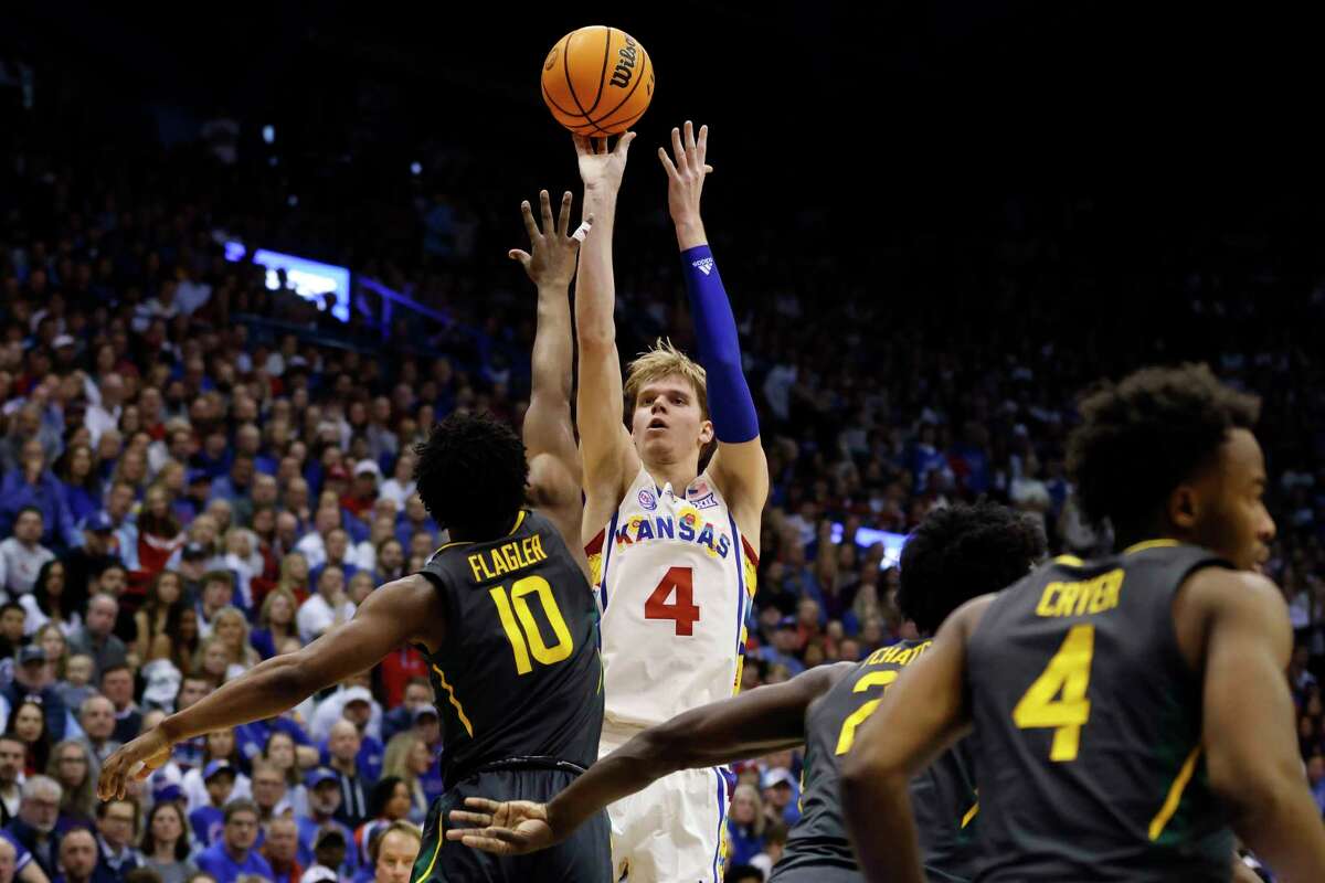 Kansas guard Gradey Dick (4) attempts a 3-point basket over the Baylor defense during the first half of an NCAA college basketball game, Saturday, Feb. 18, 2023, in Lawrence, Kan.