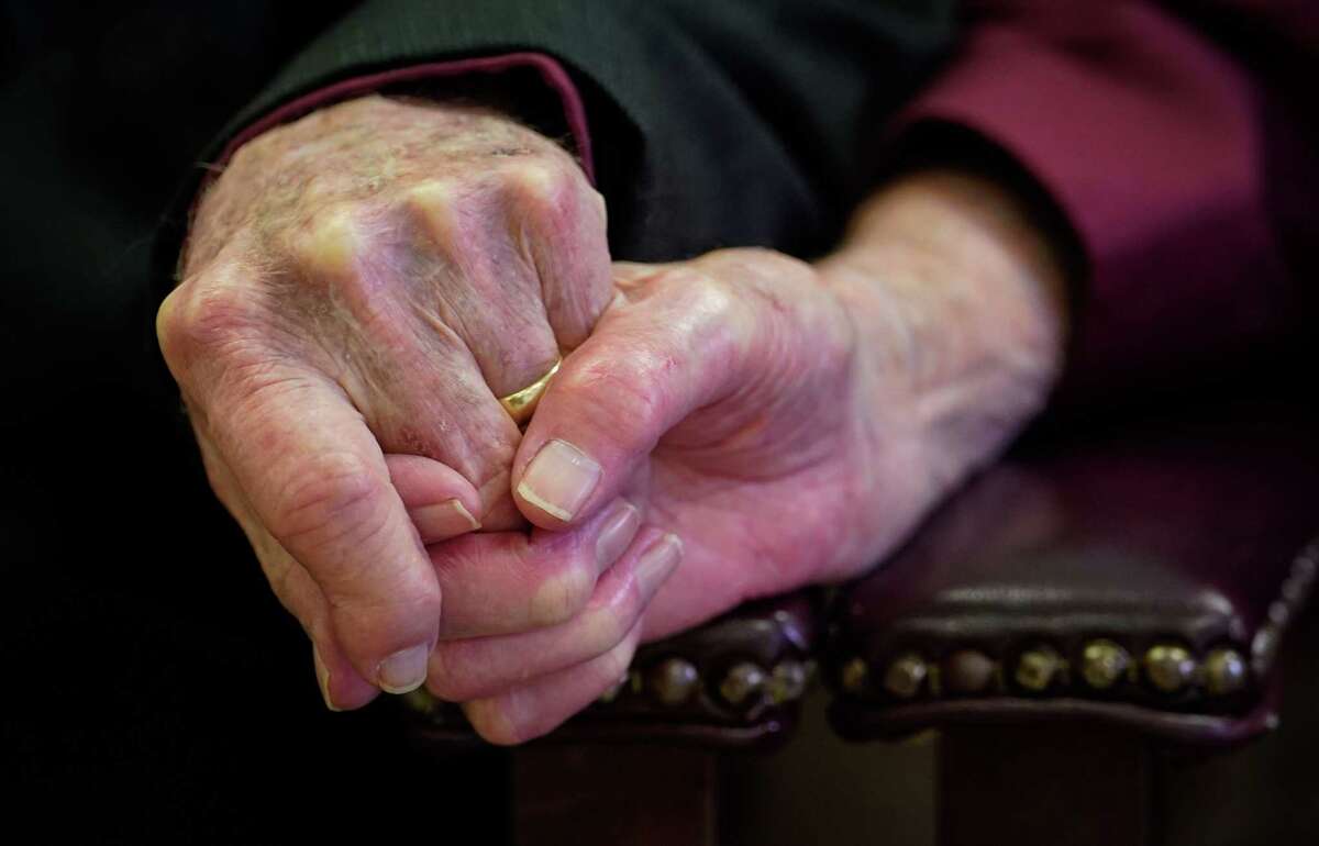 Murray Norman holds his wife Joyce’s hand during their 70th wedding anniversary celebration Saturday, Feb. 18, 2023, at the El Campo Church of Christ in El Campo. “He told me later he was smitten when he saw me,” she said.