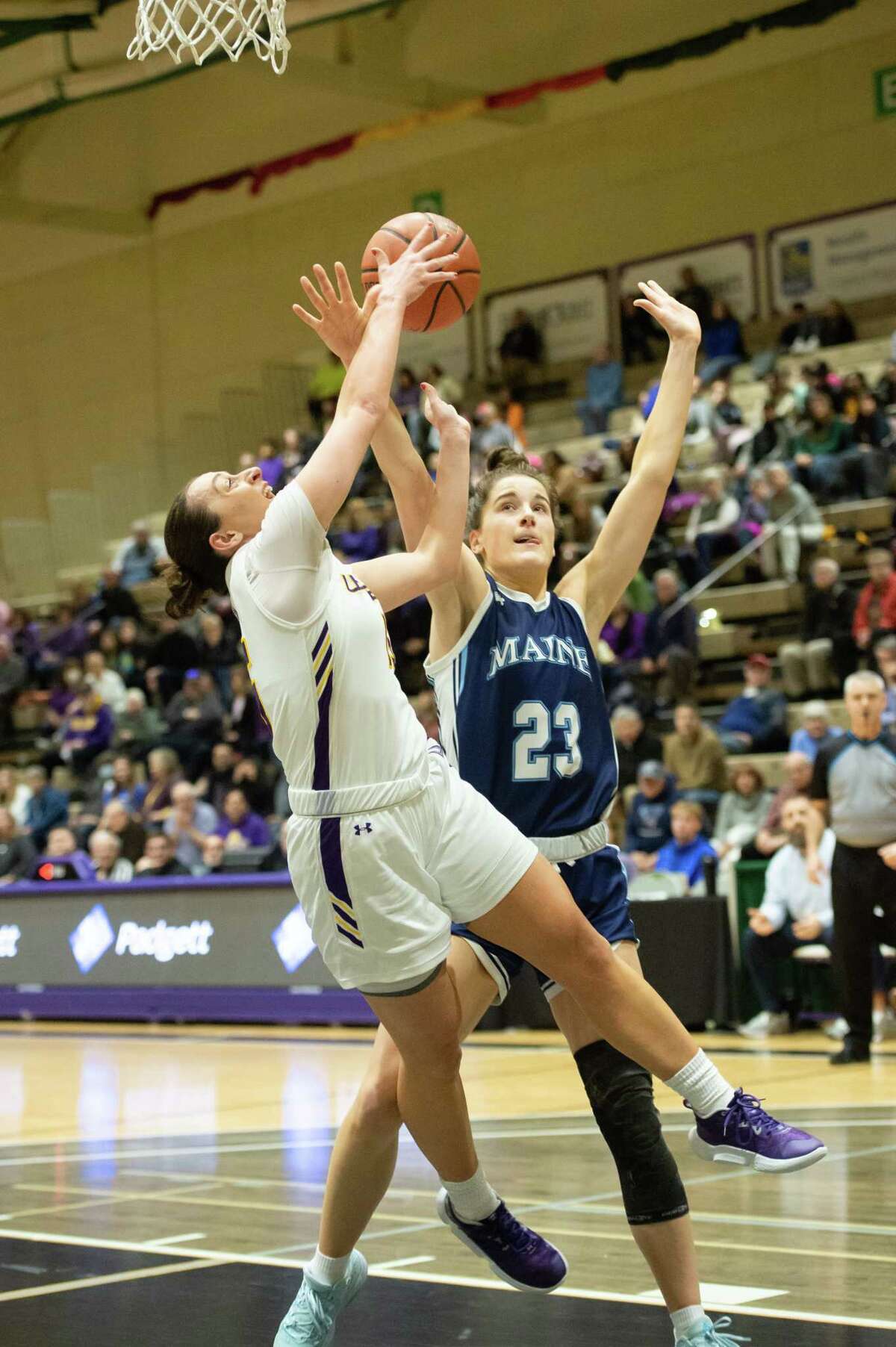 UAlbany’s Morgan Haney attempts a shot as Maine’s Abbe Lawrence pressures during a game at McDonough Sports Complex in Troy, N.Y. on Sunday, Feb. 15, 2023.