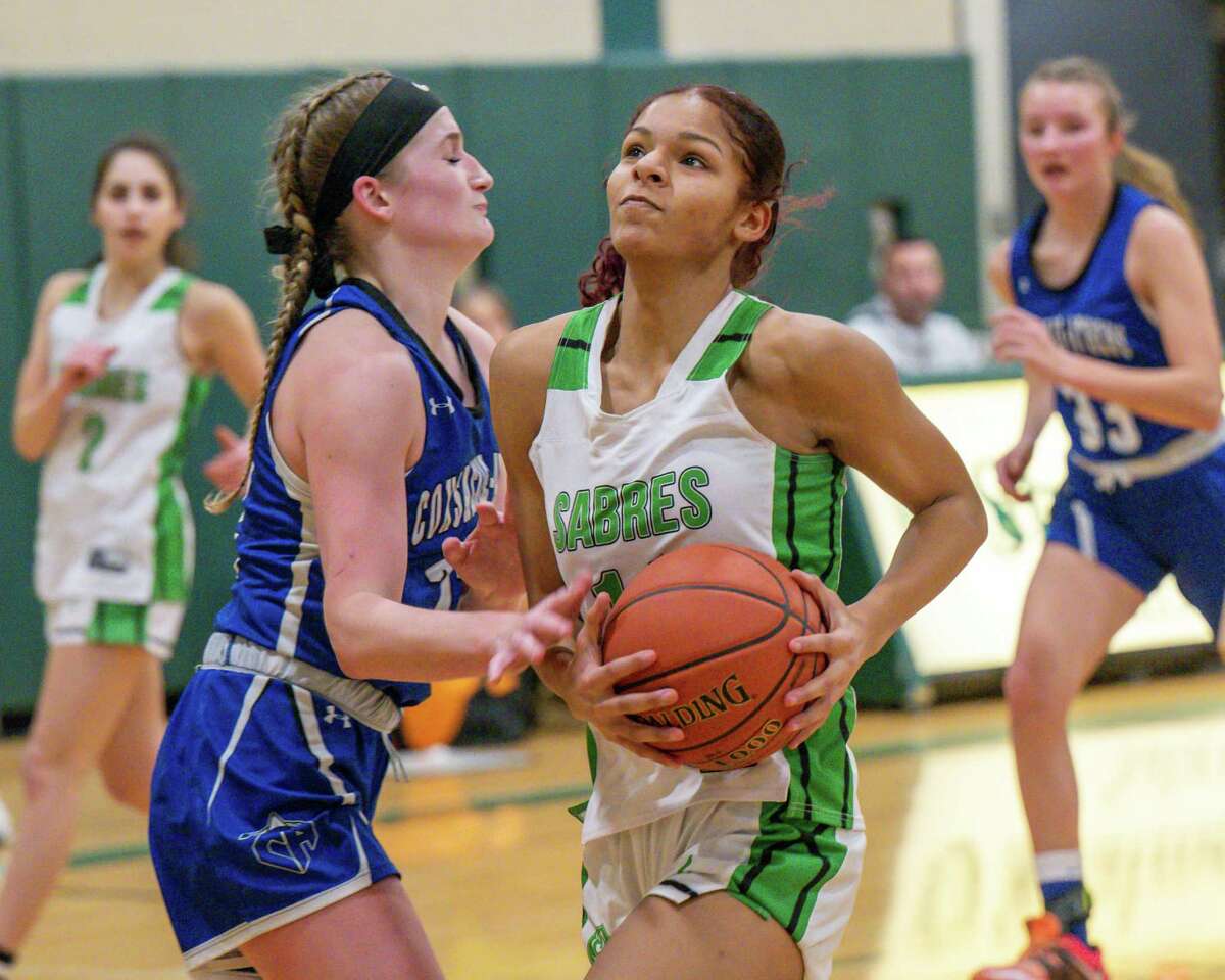 Schalmont junior Karissa Antoine drives to the basket in front of Coxsackie-Athens defender Riley Sitcer at Schalmont High School on Saturday, Feb. 18, 2023, in Rotterdam, NY.