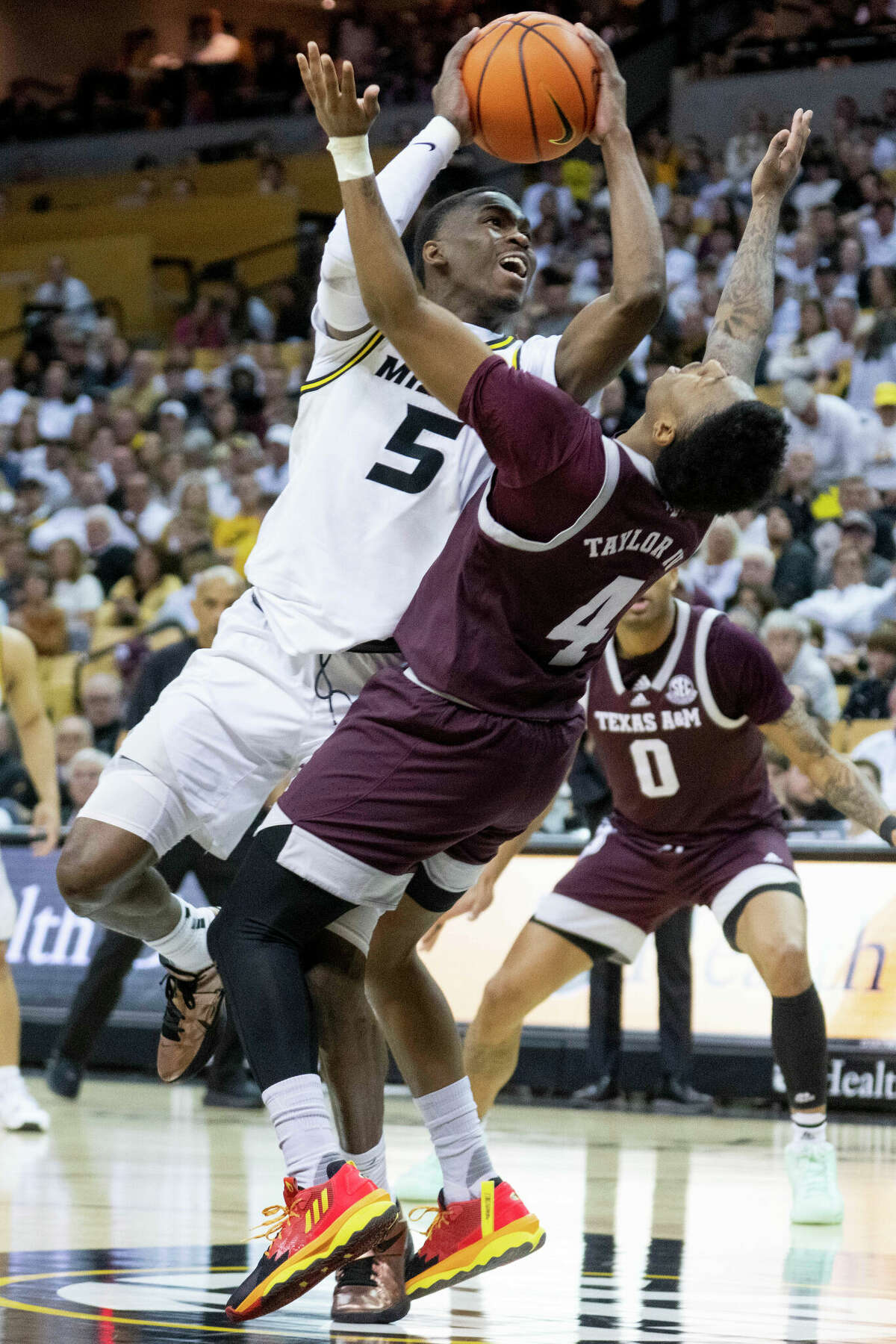 Missouri's D'Moi Hodge, top, shoots over Texas A&M's Wade Taylor IV during the second half of an NCAA college basketball game Saturday, Feb. 18, 2023, in Columbia, Mo. (AP Photo/L.G. Patterson)