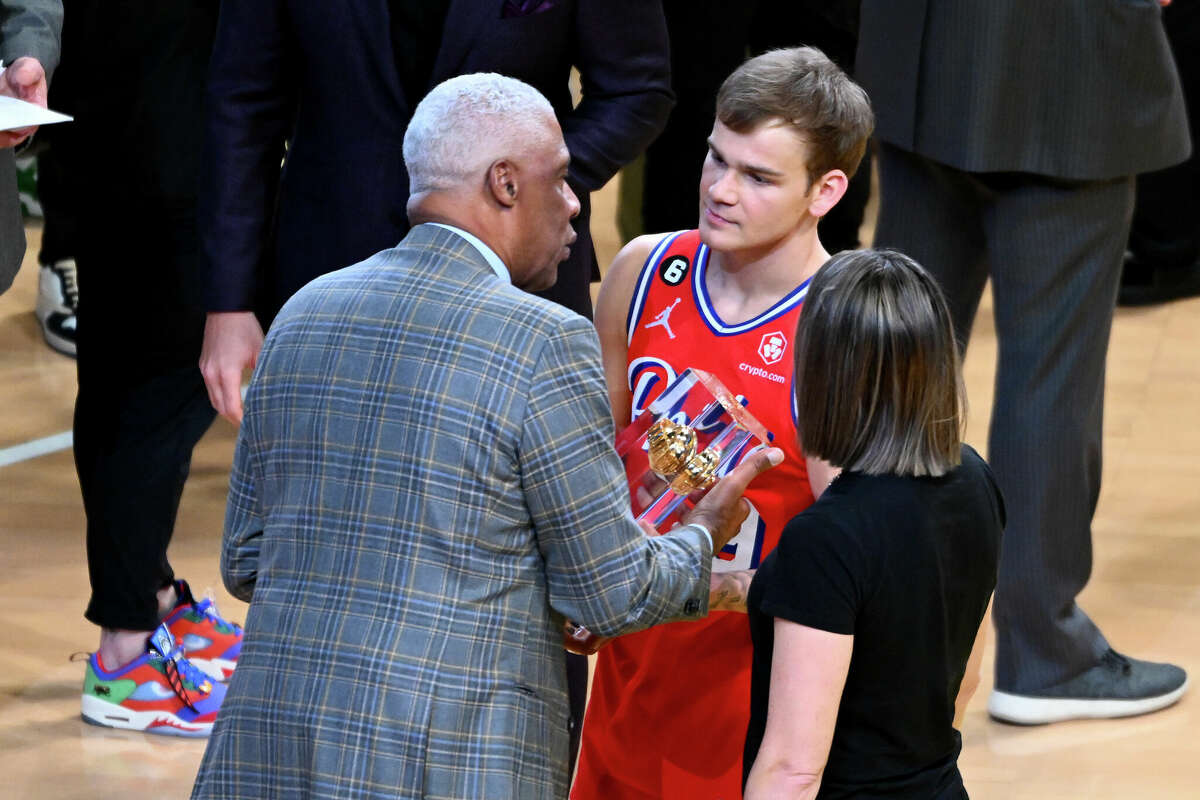 SALT LAKE CITY, UTAH - FEBRUARY 18: Former professional basketball player Julius Erving presents Mac McClung #9 of the Philadelphia 76ers with the trophy after winning the 2023 NBA All Star AT&T Slam Dunk Contest at Vivint Arena on February 18, 2023 in Salt Lake City, Utah. NOTE TO USER: User expressly acknowledges and agrees that, by downloading and or using this photograph, User is consenting to the terms and conditions of the Getty Images License Agreement. (Photo by Alex Goodlett/Getty Images)