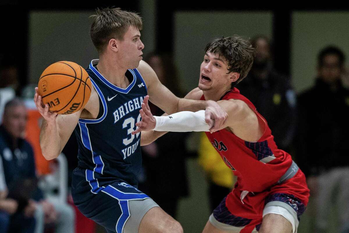 Saint Mary's guard Aidan Mahaney (20) defends as BYU guard Dallin Hall (30) looks to make a pass during second half of a NCAA basketball game in Moraga, Calif. Saturday, Feb. 18, 2023. St. Mary’s defeated BYU 71-65.
