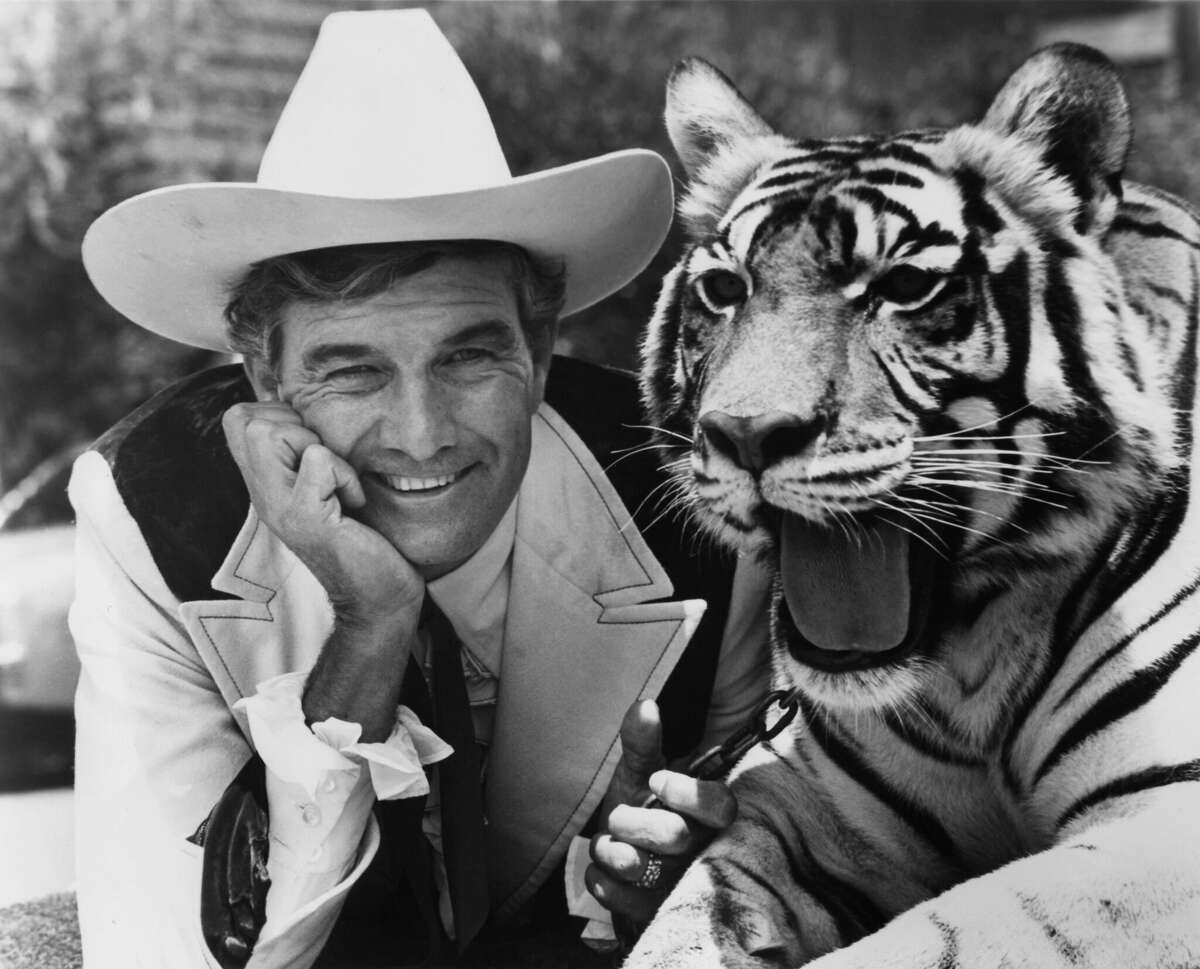 Car salesman Cal Worthington poses for a portrait with his "dog Spot" in 1976 in Long Beach, Calif.