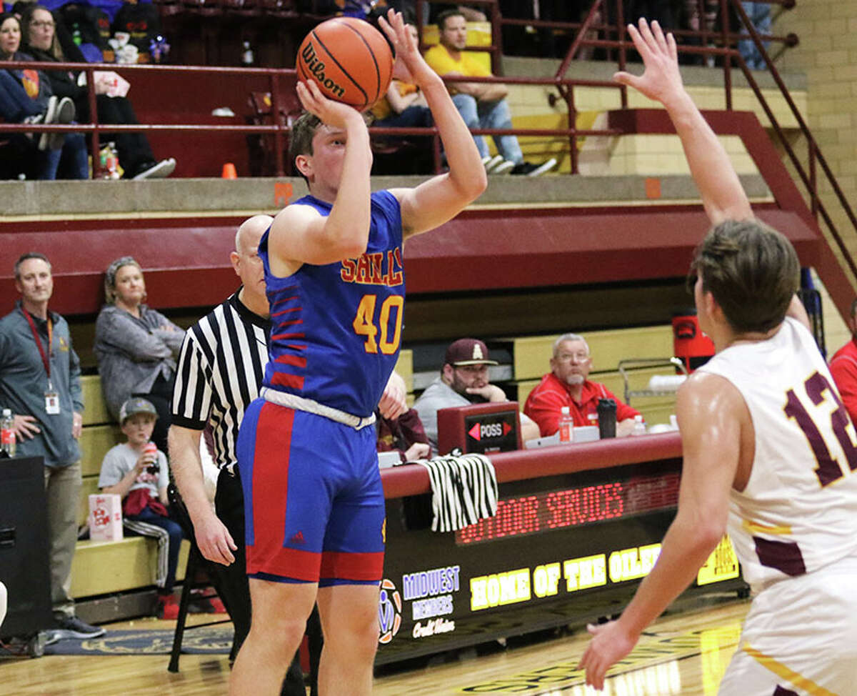 Roxana's Aidan Briggs (left), shown shooting a 3-pointer over EA-WR's Tyler Robinson in a game earlier this month at Wood River, made two free throws Saturday to give the Shells a 45-44 win over the Oilers in a Class 2A regional quarterfinal at Memorial Gym in Wood River.