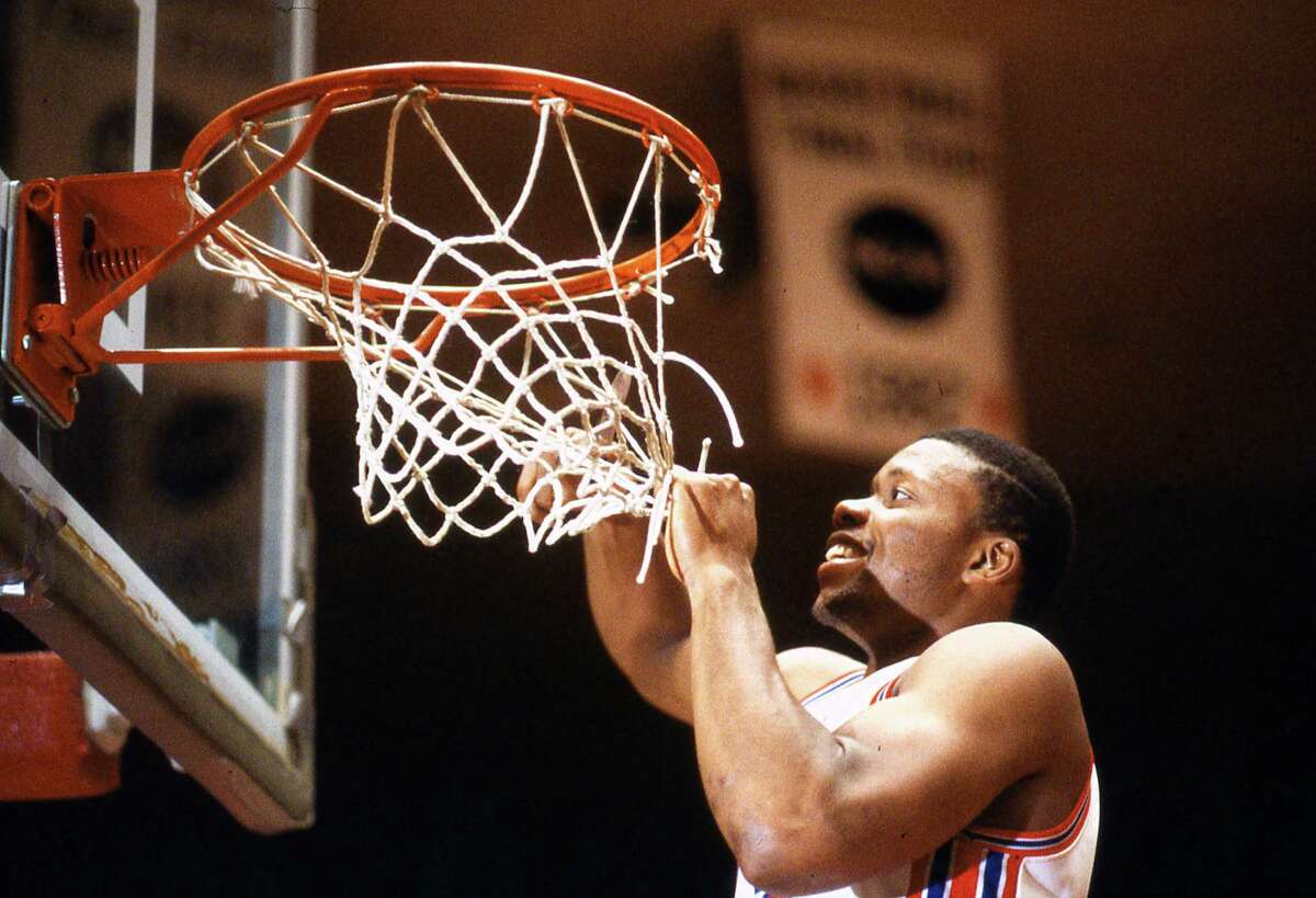 02/29/1984 - Houston Cougars Michael Young cuts down net from goal in celebration after the Cougars beat the Baylor Bears, 80-65, for their second consecutive Southwest Conference title.