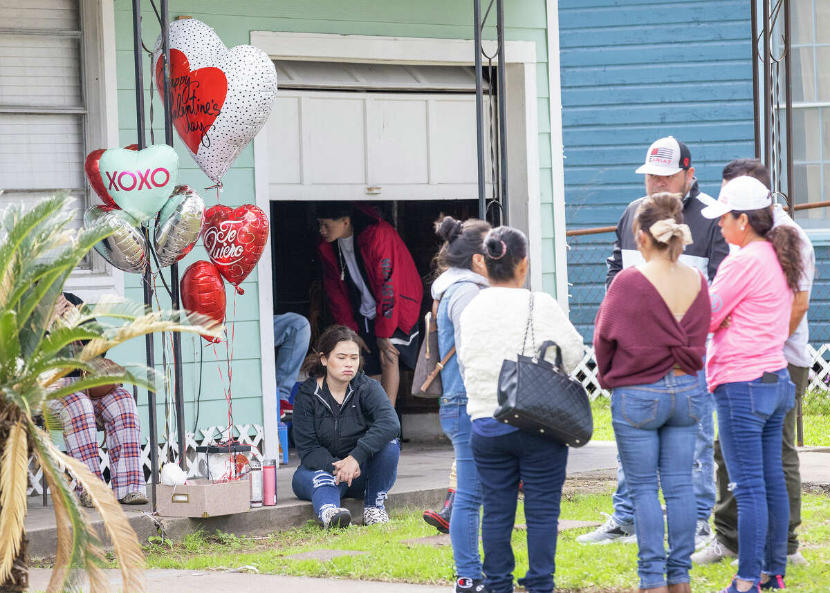 People gather outside a home Sunday, Feb. 19, 2023, in Galena Park, Texas, where Harris County Sheriff Ed Gonzalez said three teenage girls, including one who was pregnant, were fatally shot Saturday night by man, who also sexually assaulted a 12-year-old girl who later escaped, then fatally shot himself.