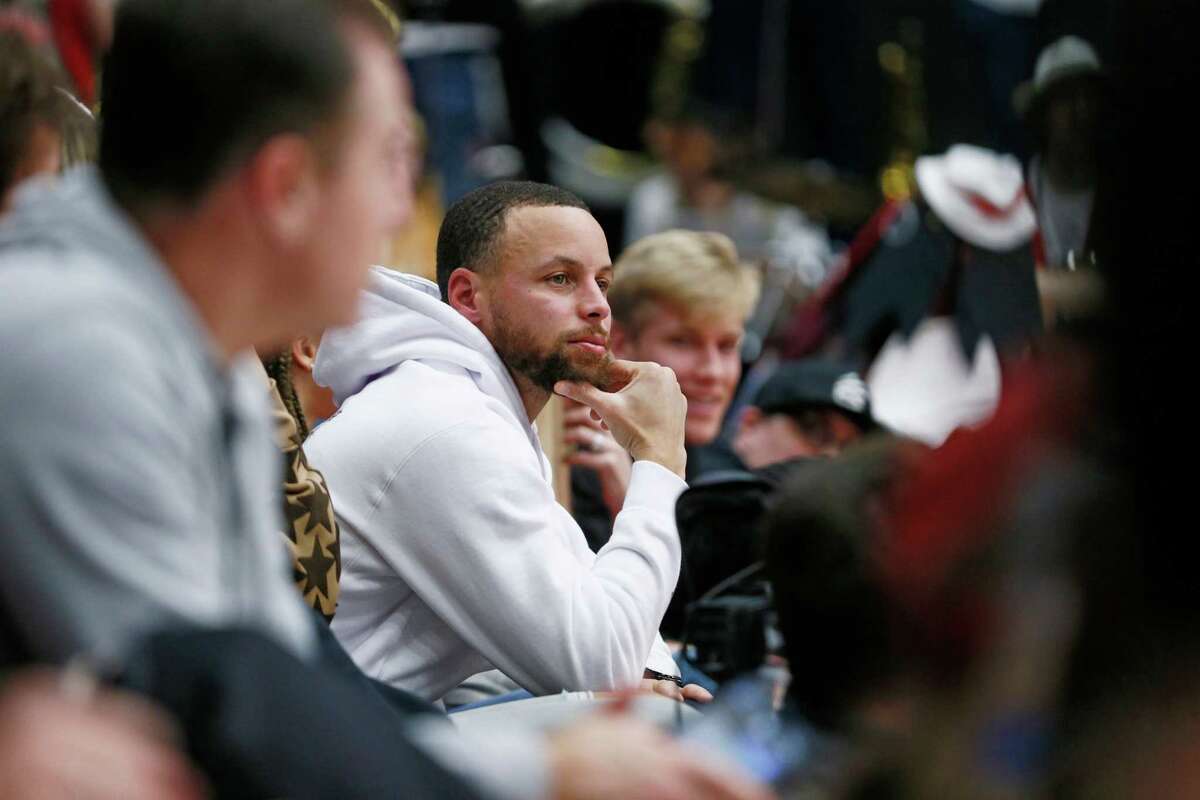 Warriors guard Stephen Curry, shown at a Stanford women’s basketball game on Feb. 17, is out with a knew injury.