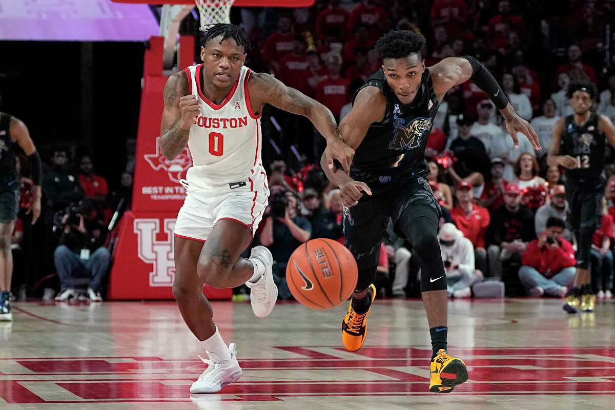 Houston guard Marcus Sasser (0) and Memphis guard Keonte Kennedy (1) chase the ball during the first half of an NCAA college basketball game Sunday, Feb. 19, 2023, in Houston. (AP Photo/Kevin M. Cox)