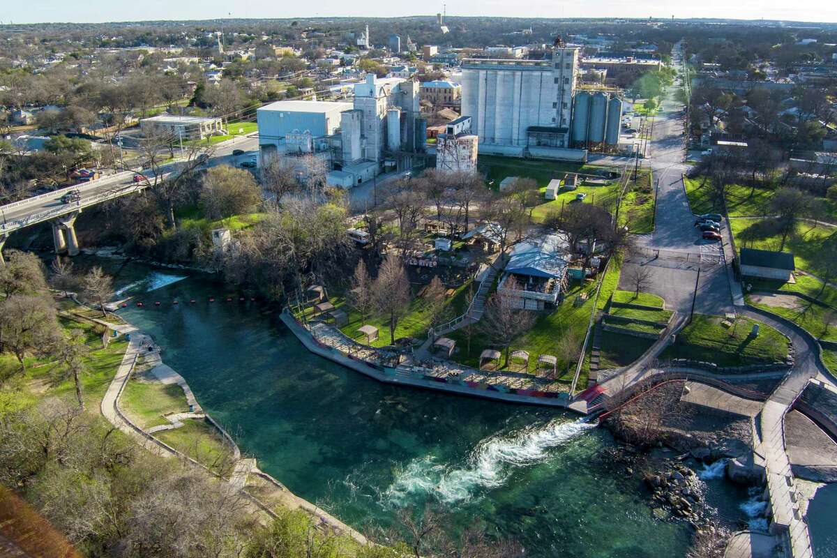 The Dittlinger Mill, operated by ADM Inc., is seen Friday, Feb. 17, 2023 near the Comal River in New Braunfels. The mill, which has produced wheat and flour products in New Braunfels since it opened in 1886, is closing at the end of March.