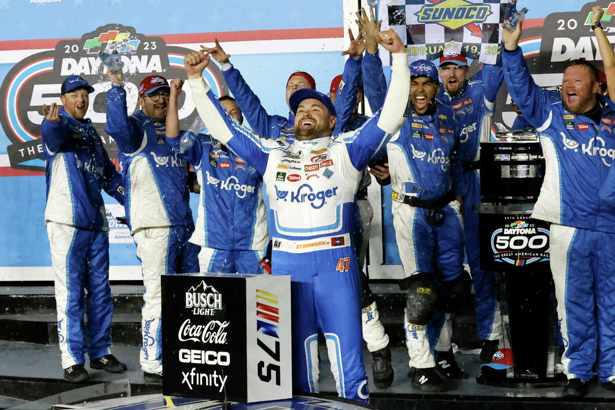 Ricky Stenhouse Jr., center, celebrates in Victory Lane after winning the NASCAR Daytona 500 auto race at Daytona International Speedway, Sunday, Feb. 19, 2023, in Daytona Beach, Fla.