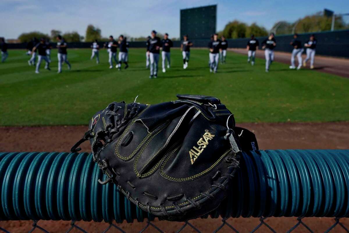 Chicago White Sox players warm up during a spring training baseball practice Saturday in Phoenix.