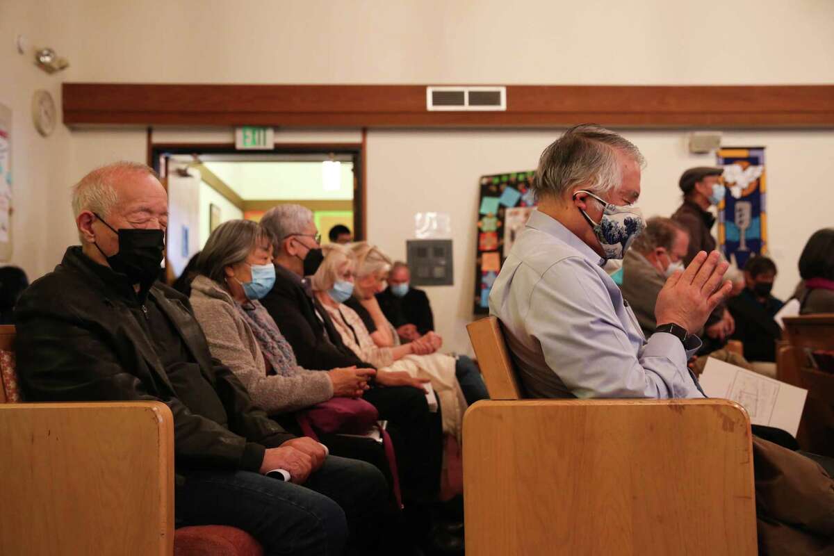Attendees of the Bay Area Day of Remembrance pray during the program at Christ United Presbyterian Church in Japantown, San Francisco, Calif., on Sunday, Feb. 19, 2023.