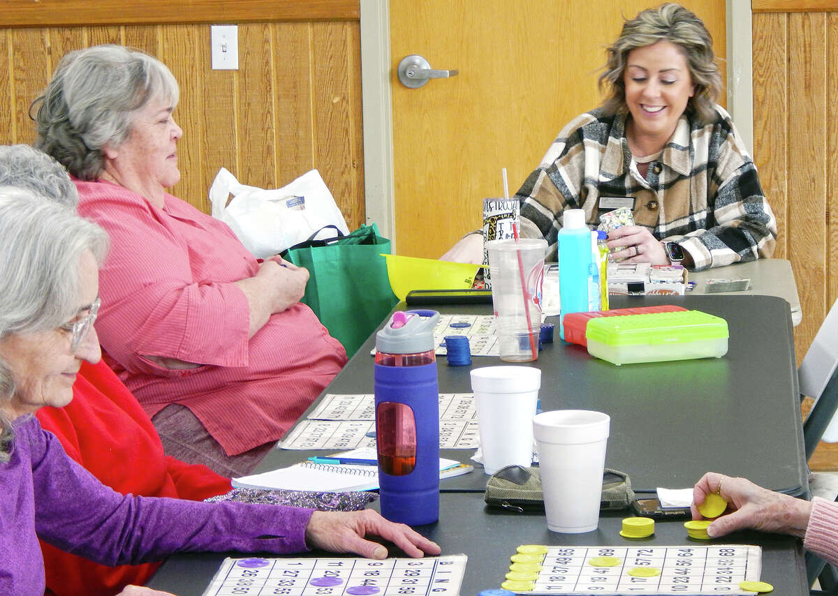 Volunteer Brandy Nergenah (right) of Prairie Village Health Care calls a bingo game at Jacksonville Area Senior Center.
