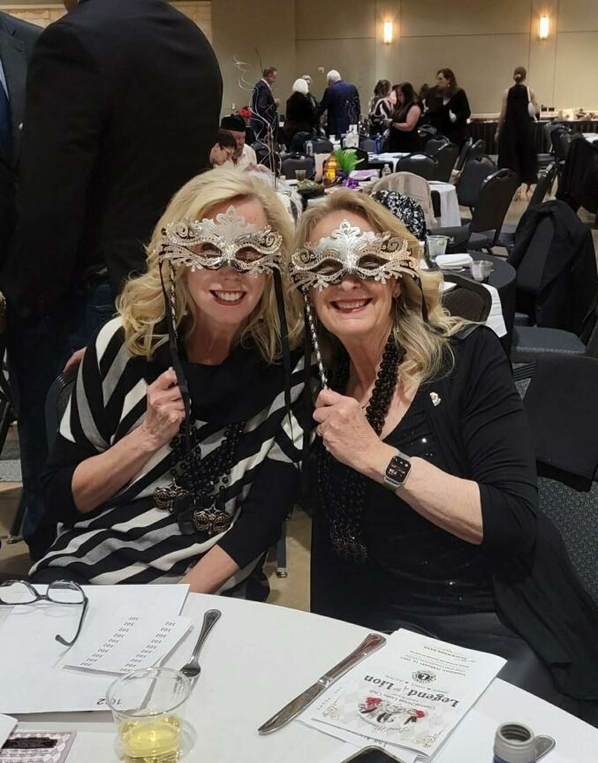 It’s a Masquerade - As Lions club members and sisters Junette Mihelich (l) and Helen Thornton (r) show off their mask at the Conroe Noon Lions Club annual Legend of the Lion - Dinner/Dance & Auction last week.