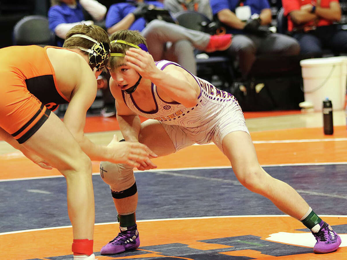 CM's Bryce Griffin (right) looks for an opening against Washington's Kannon Webster in their 145-pound championship match on Saturday night in the Class 2A state tournament at State Farm Center in Champaign.