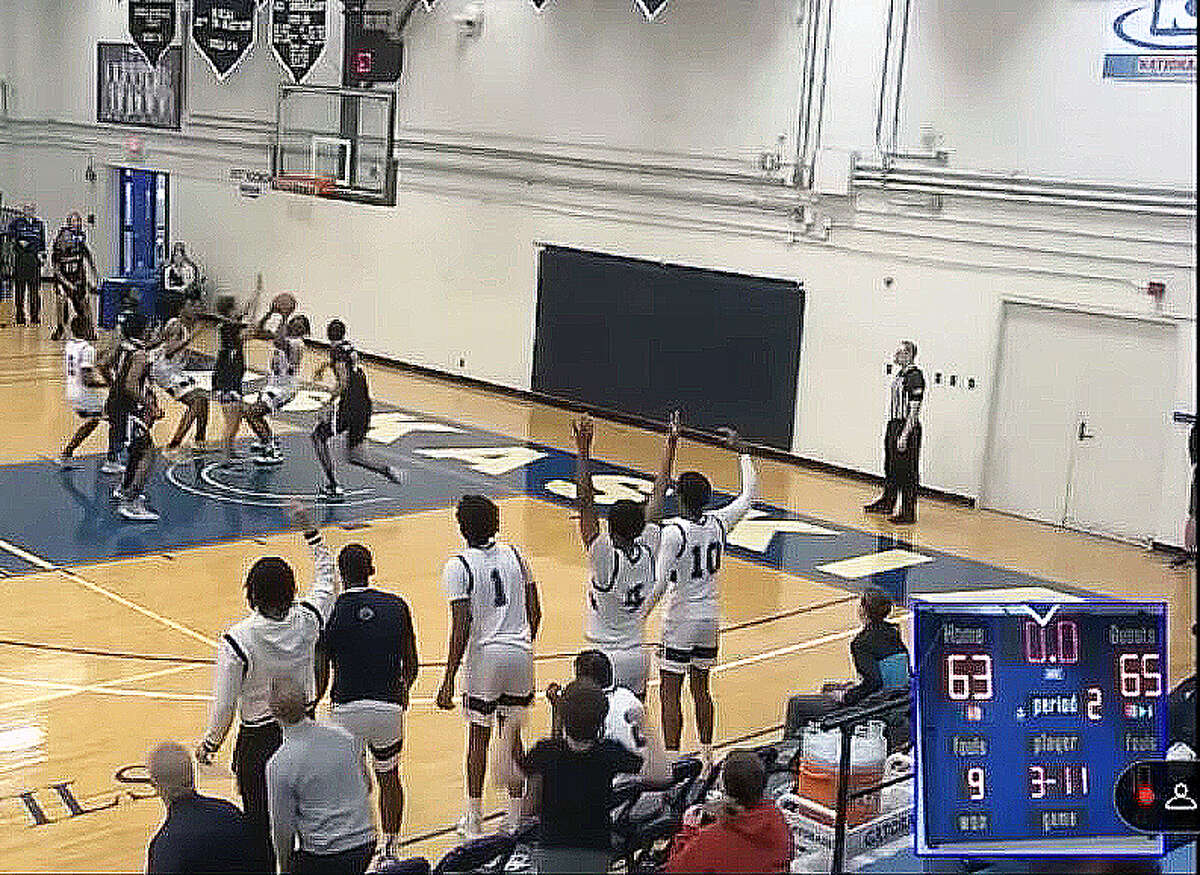 A screenshot from a Kaskaskia College video appears to show Kaskaskia player Ezereke Dawson (in white) under the basket with the ball in his hands as the scoreboard clock (lower right) indicates no time remaining in Saturday's game in Centralia against Lewis and Clark. Dawson subsequently made a layup. Officials ruled the basket came before had expired, tying the score. Kaskaskia then went on to beat LCCC 80-76 in overtime.