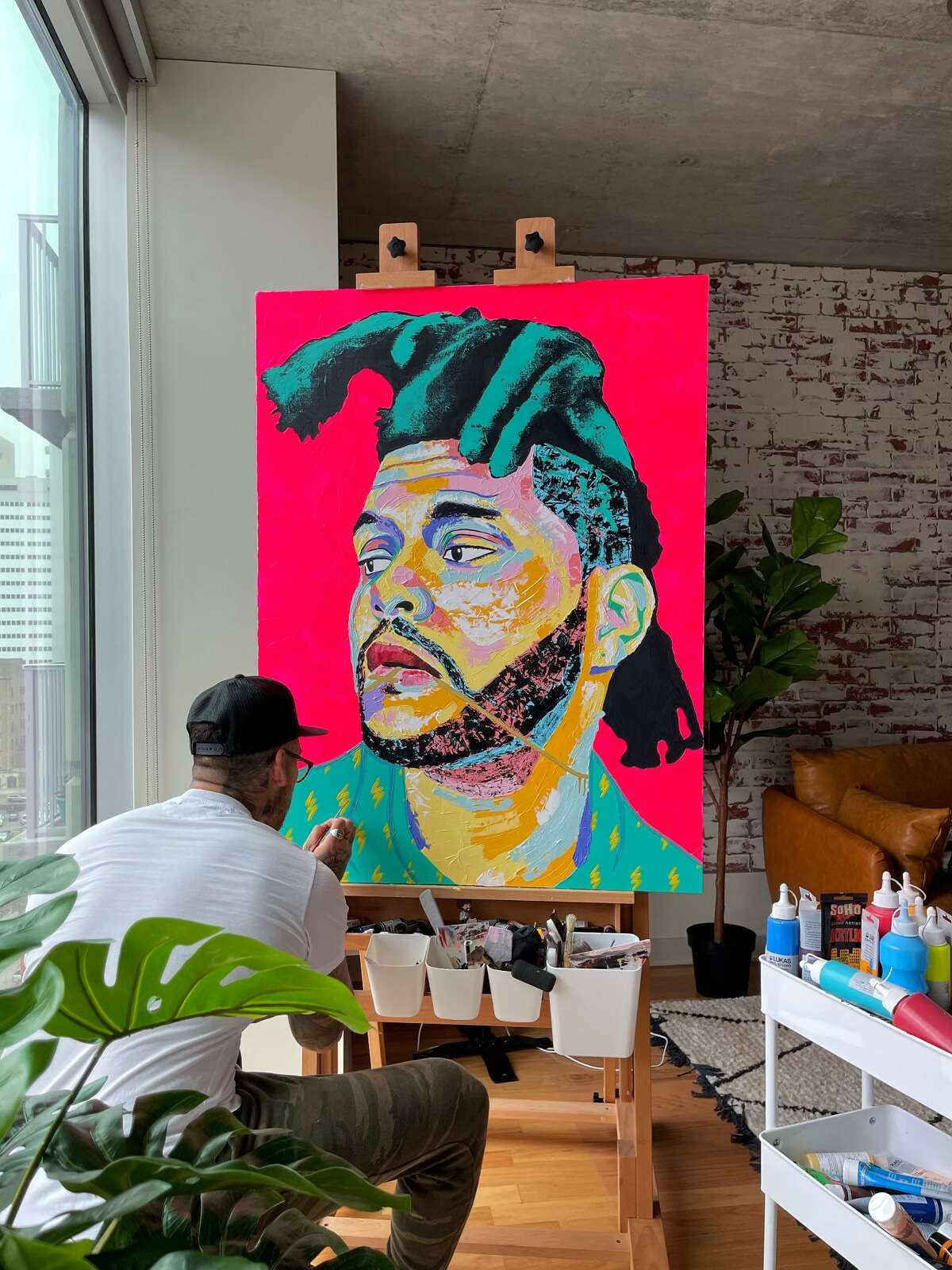 Israel Rodriguez completes a mural of The Weeknd in his studio.