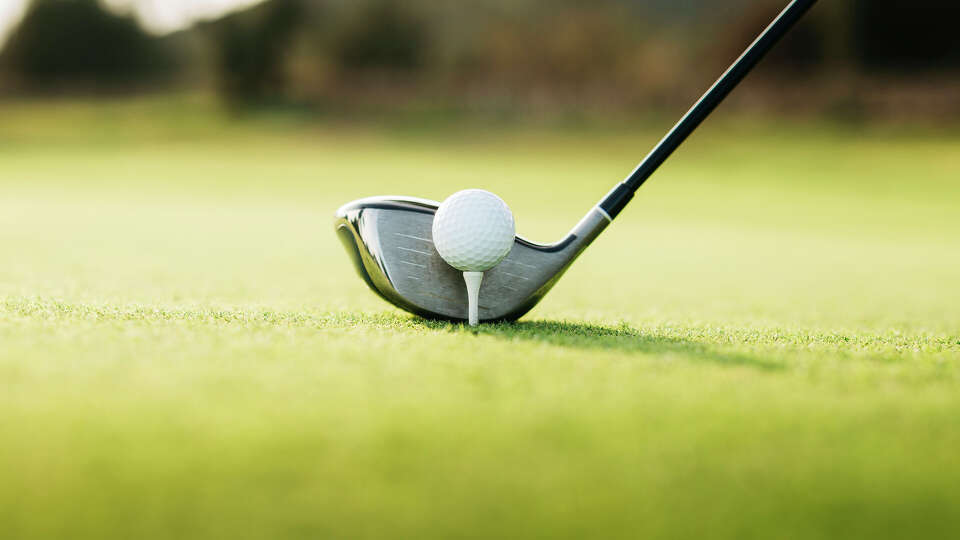 Close-Up Of Golf Ball On tee on a golf course - stock photo