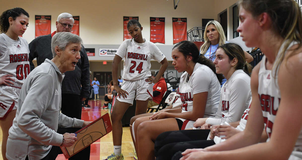 Rosehill Christian Head Girls Basketball Coach Steve Krantz, left, pumps up his team during a timeout between the 3rd and 4th quarters in their TAPPS 3A District 5 matchup at Rosehill Christian High School on Jan. 17, 2023.