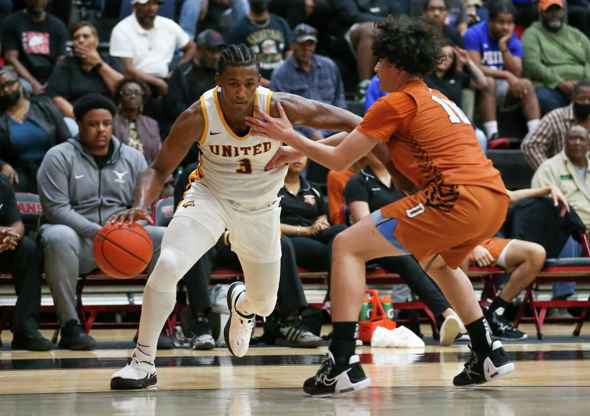 Beaumont United senior guard Wesley Yates drives the ball against a Dobie defender during a first-round playoff game at Port Arthur Memorial High School. 