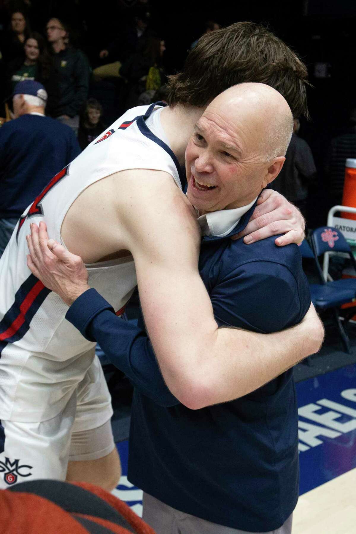Saint Mary's head coach Randy Bennett, right, gets a hug from guard Alex Ducas (44) after notching his 500th career coaching victory, with a 68-59 victory over San Francisco in an NCAA college basketball game, Thursday, Feb. 2, 2023, in Moraga, Calif. (AP Photo/D. Ross Cameron)